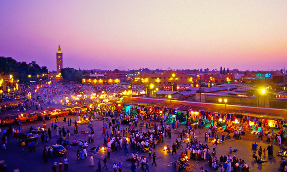 Panoramic view of Marrakech medina with the Koutoubia minaret at sunset